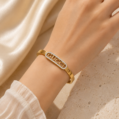 Gold Gucci bracelet on a hand
