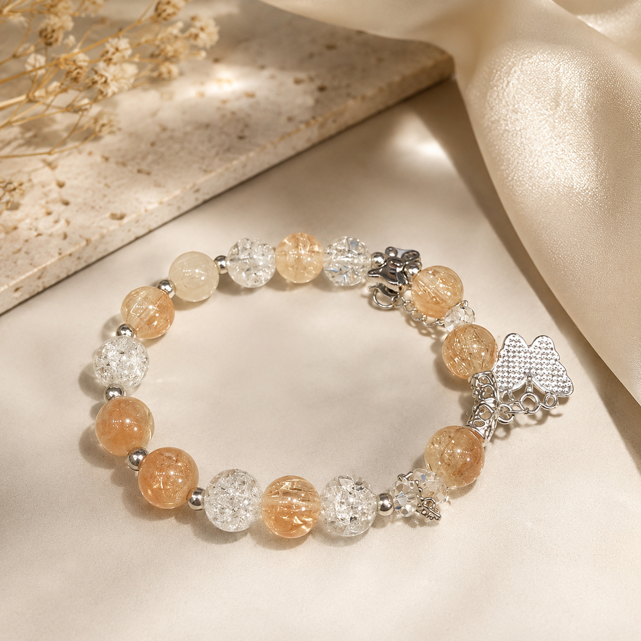 Women’s peach beaded bracelet with clear beads, silver-tone accents and flower charm